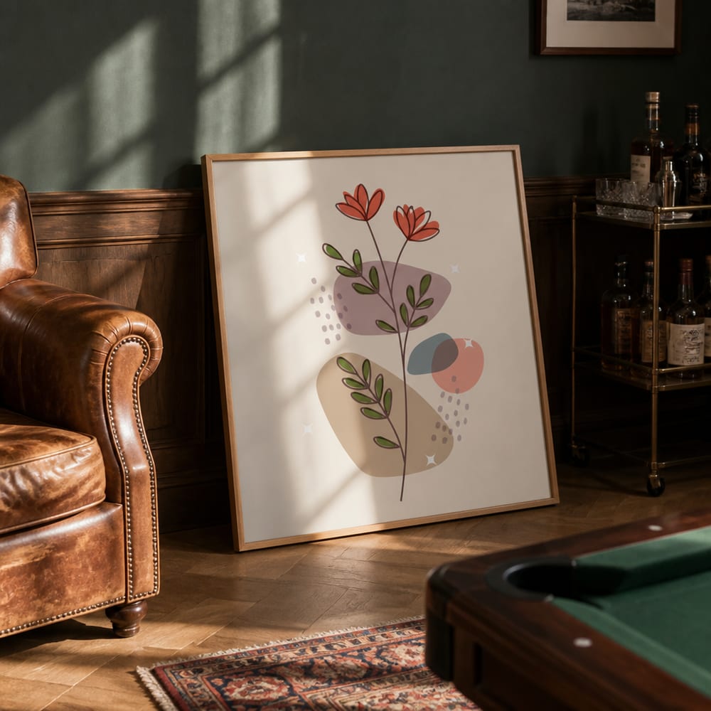 Framed poster leaning on the floor beside a leather club chair in a man cave